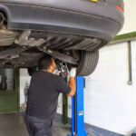 Aaron Inspects the Underneath of a Car